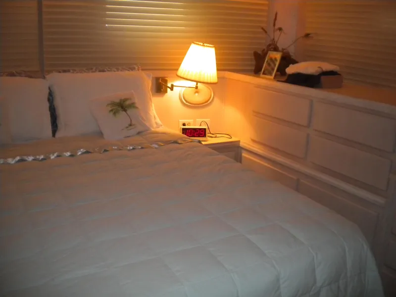 Slide: The Image of Cozy bedroom interior of 1987 Hatteras 53 Motor Yacht with soft lighting and elegant decor. - 32
