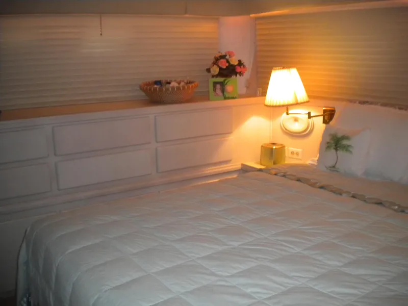 Slide: The Image of Cozy bedroom interior of 1987 Hatteras 53 Motor Yacht with soft lighting and floral decor. - 33