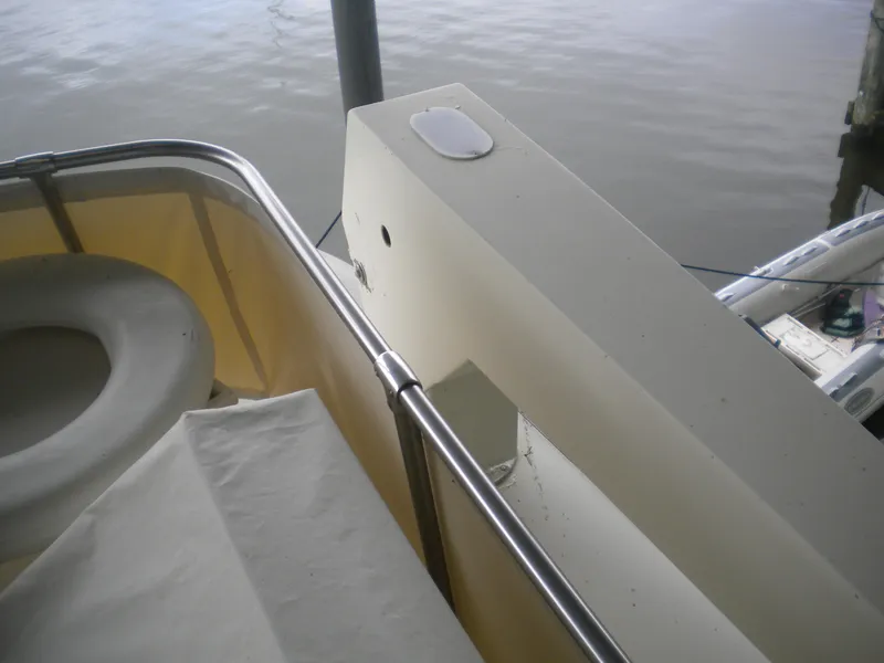 Slide: The Image of 1987 Hatteras 53 Motor Yacht deck view with railing and water backdrop. - 38
