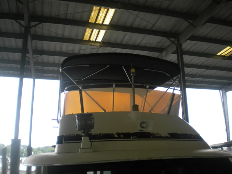 Slide: The Image of 1987 Hatteras 53 Motor Yacht under covered dock, front view. - 4