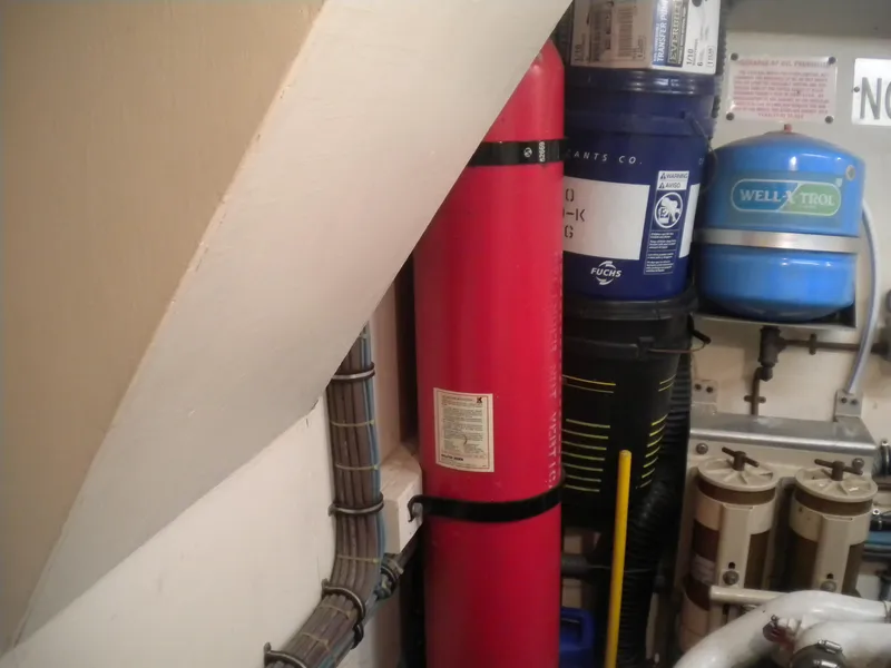 Slide: The Image of Engine room of 1987 Hatteras 53 Motor Yacht with equipment and storage tanks. - 44