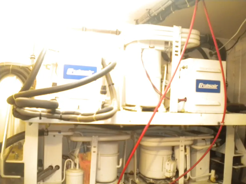 Slide: The Image of Engine room of 1987 Hatteras 53 Motor Yacht with mechanical equipment and wiring. - 45
