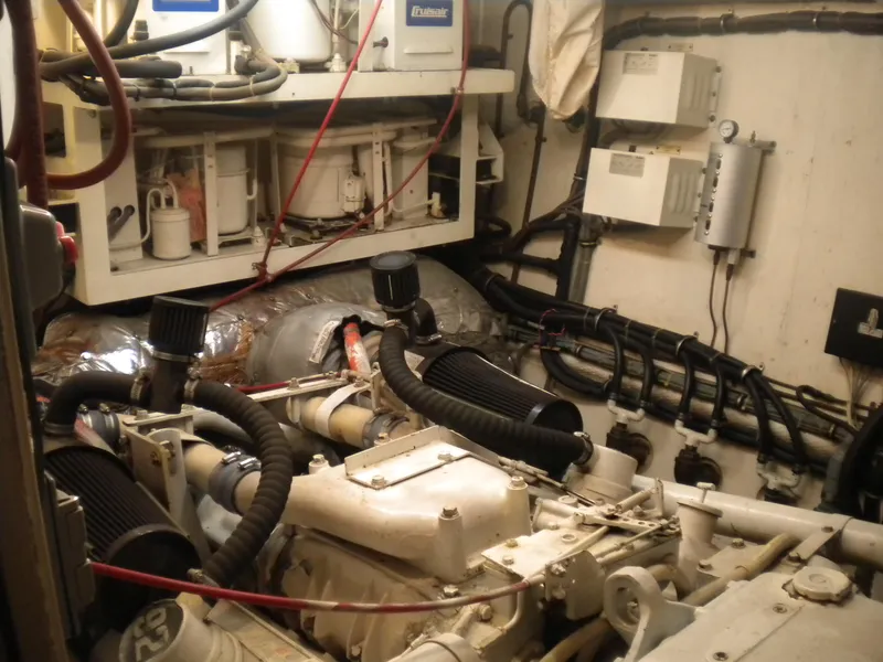 Slide: The Image of Engine room of 1987 Hatteras 53 Motor Yacht with visible machinery and wiring. - 46