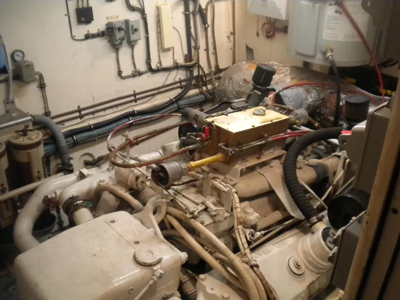 Slide: The Image of Engine room of a 1987 Hatteras 53 Motor Yacht, showcasing mechanical components and wiring. - 47