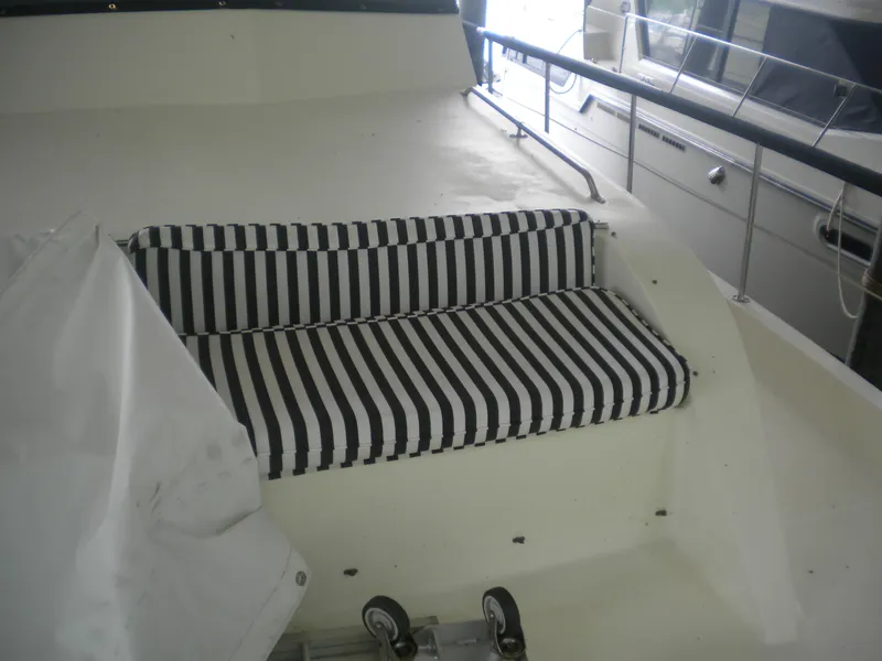 Slide: The Image of Striped seating on 1987 Hatteras 53 Motor Yacht deck, featuring black and white cushions. - 6