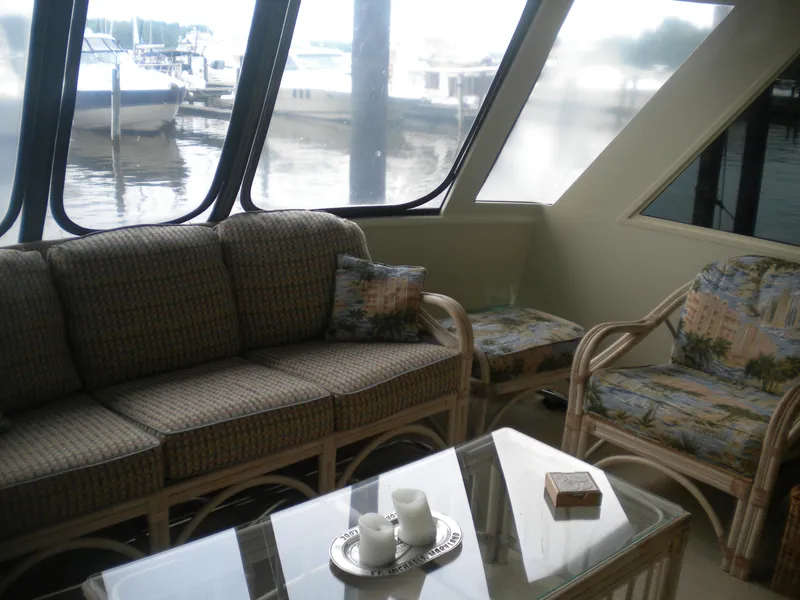 Slide: The Image of Interior of 1987 Hatteras 53 Motor Yacht with comfortable seating and waterfront view. - 7