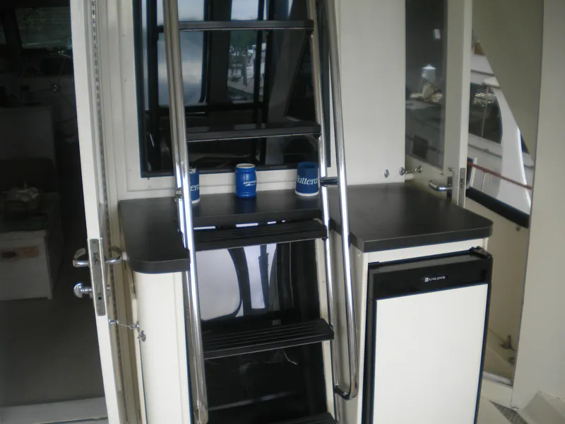 Slide: The Image of Interior view of 1987 Hatteras 53 Motor Yacht with stairs and compact kitchenette. - 9