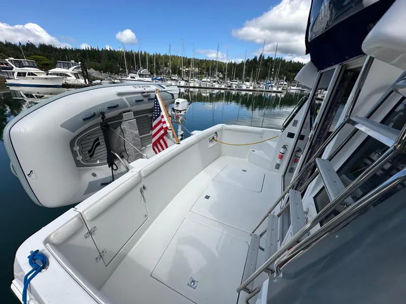 Slide: The Image of 1996 Carver Voyager boat docked in a marina with an American flag. - 12