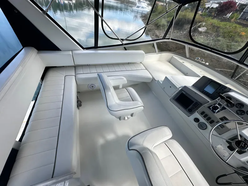 Slide: The Image of Interior of a 1996 Carver Voyager boat with white seating and control panel. - 16