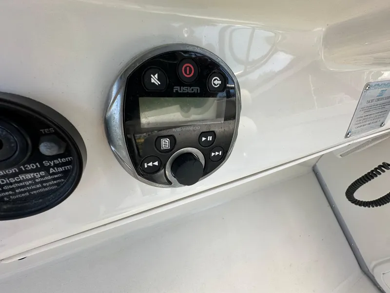 Slide: The Image of Control panel on a 1996 Carver Voyager boat dashboard with Fusion audio system. - 21