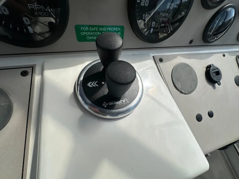 Slide: The Image of Control panel of a 1996 Carver Voyager boat with joystick and gauges. - 22