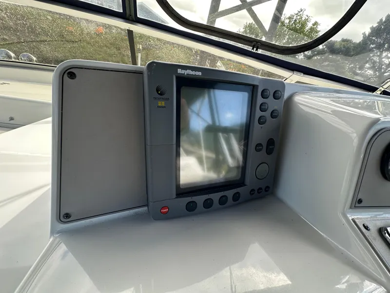 Slide: The Image of Navigation system on 1996 Carver Voyager boat dashboard, featuring Raytheon display. - 23
