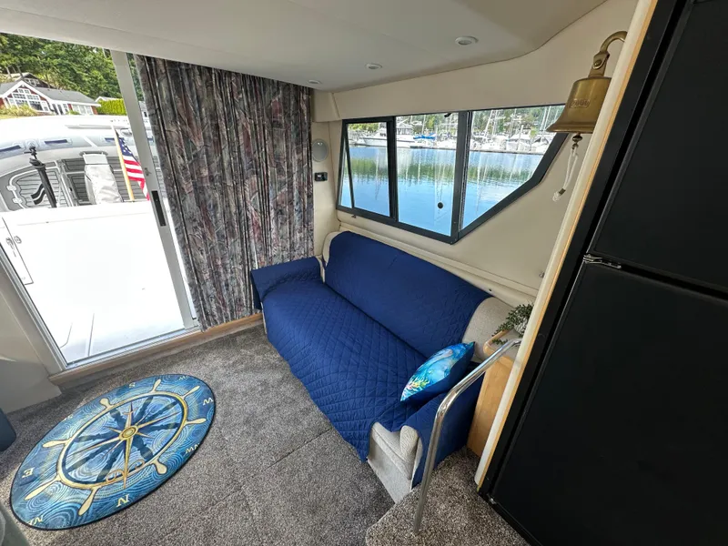 Slide: The Image of Interior of a 1996 Carver Voyager boat with blue sofa and nautical decor. - 28