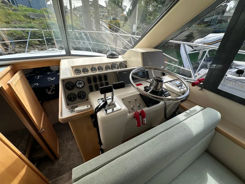 Slide: The Image of Interior helm of 1996 Carver Voyager boat with steering wheel and control panel. - 35