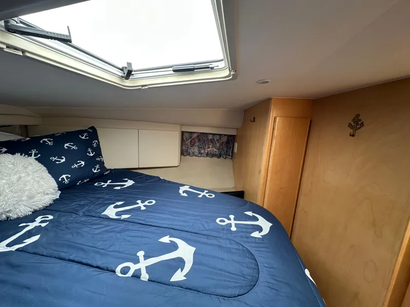 Slide: The Image of Cozy cabin interior of 1996 Carver Voyager with anchor-themed bedding and skylight. - 39