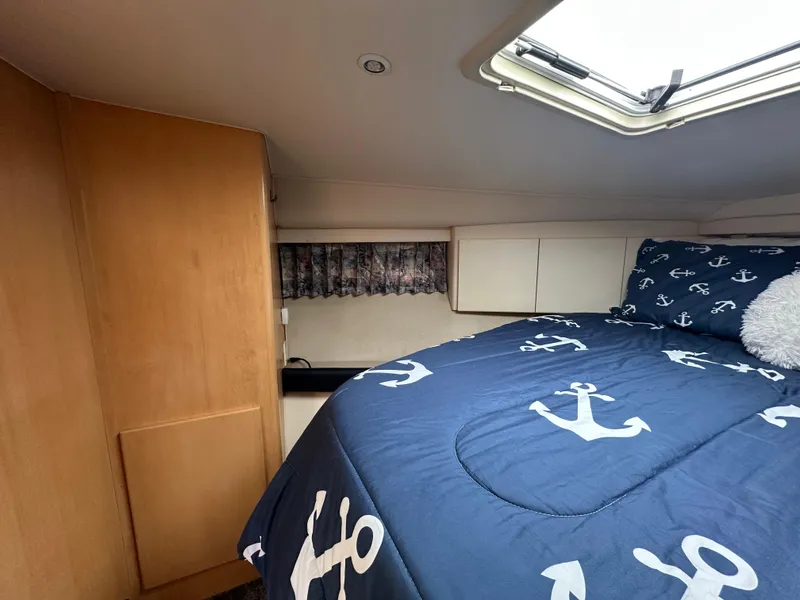 Slide: The Image of Cozy cabin interior of 1996 Carver Voyager with anchor-themed bedding and skylight. - 40