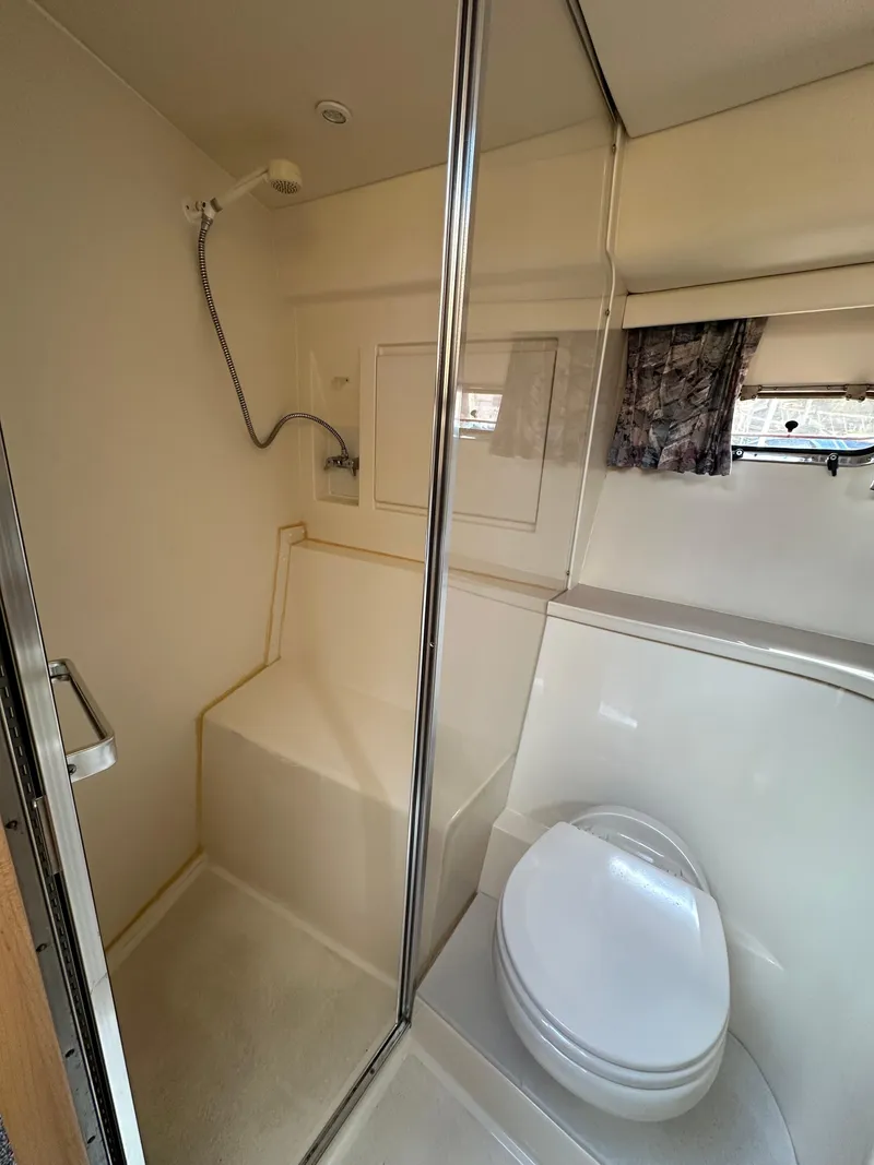 Slide: The Image of 1996 Carver Voyager bathroom with shower, toilet, and window. - 42