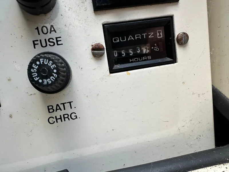 Slide: The Image of Close-up of a 1996 Carver Voyager control panel with 10A fuse and hour meter. - 48