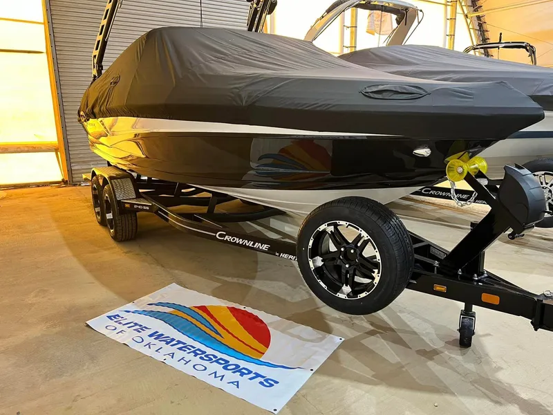 The Image of 2024 Crownline 240SS Surf boat covered, on trailer at Elite Watersports of Oklahoma. - 0