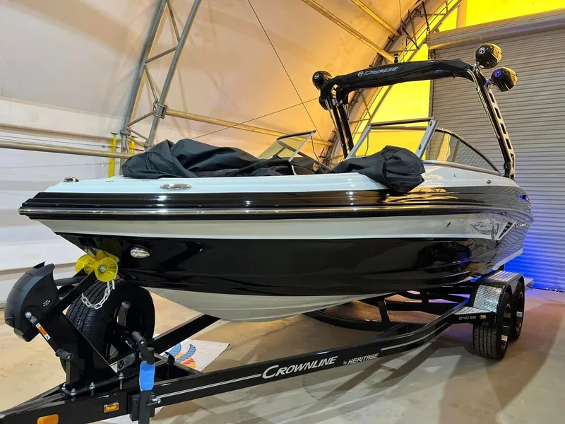Slide: The Image of 2024 Crownline 240SS Surf boat on trailer in indoor storage facility. - 4