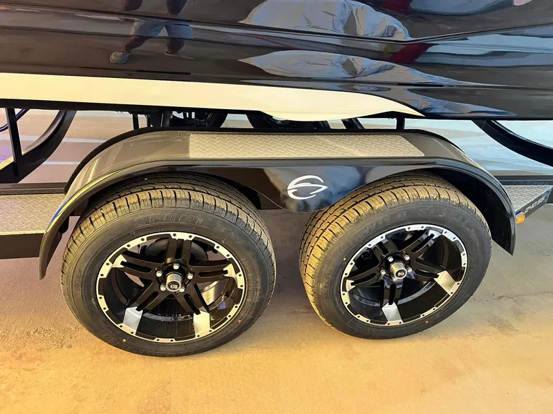 Slide: The Image of 2024 Crownline 240SS Surf trailer with dual black alloy wheels. - 6
