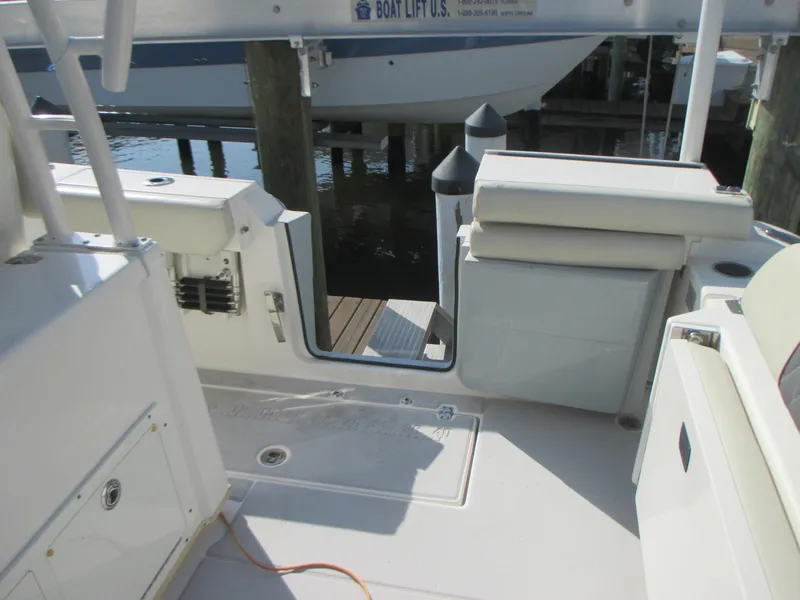 Slide: The Image of 2018 Cobia 301 Center Console boat storage and utility area with compartments. - 10