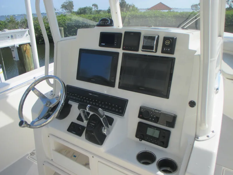 Slide: The Image of 2018 Cobia 301 Center Console boat interior with seating and storage. - 13
