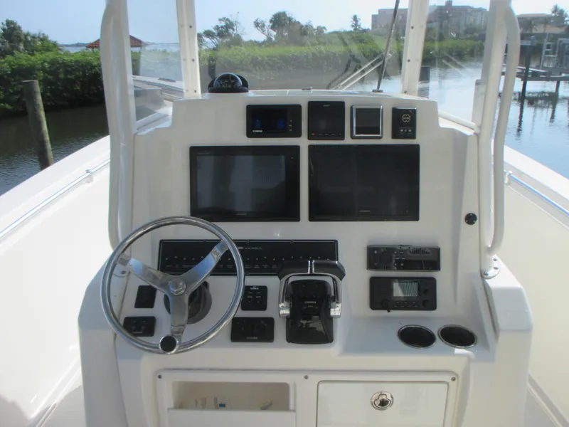 Slide: The Image of 2018 Cobia 301 Center Console boat with foldable seating and storage compartments. - 14