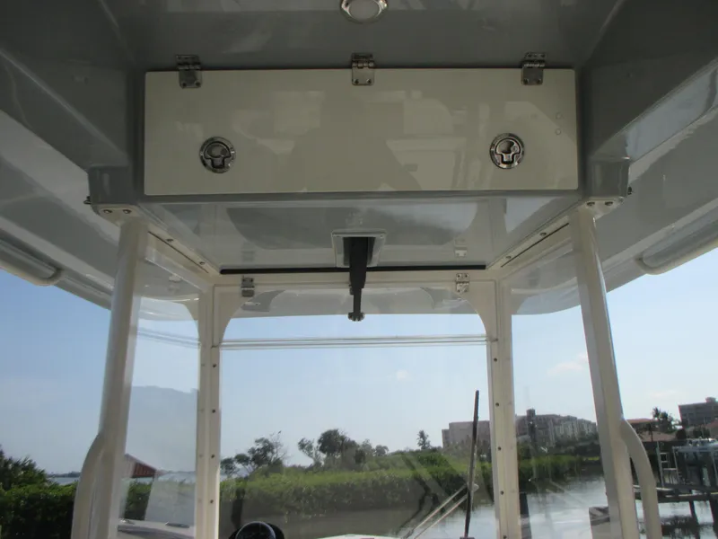 Slide: The Image of 2018 Cobia 301 Center Console boat dashboard with steering wheel and electronic controls. - 15