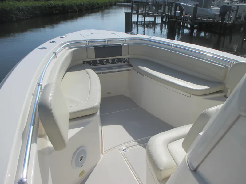 Slide: The Image of 2018 Cobia 301 Center Console boat interior with storage compartment and clear view of waterway. - 17