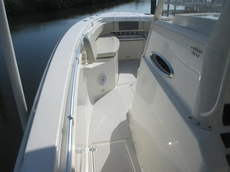 Slide: The Image of 2018 Cobia 301 Center Console boat seats with steering wheel, showcasing luxury and comfort. - 18