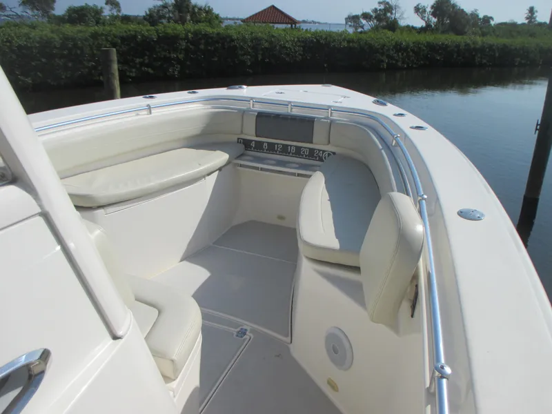 Slide: The Image of 2018 Cobia 301 Center Console boat interior with cushioned seating and sleek design. - 19