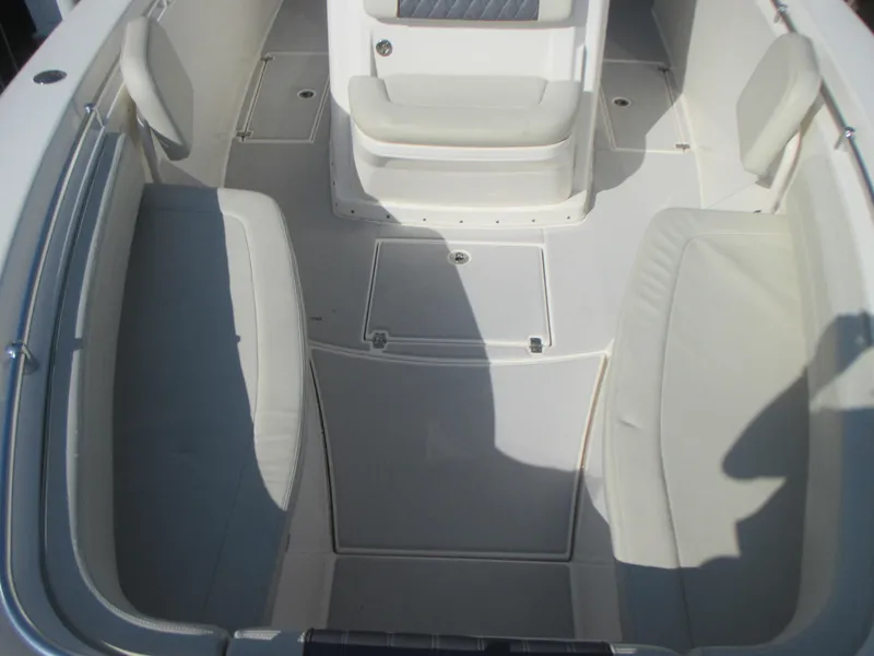 Slide: The Image of 2018 Cobia 301 Center Console boat interior with cushioned seating and sleek design. - 21