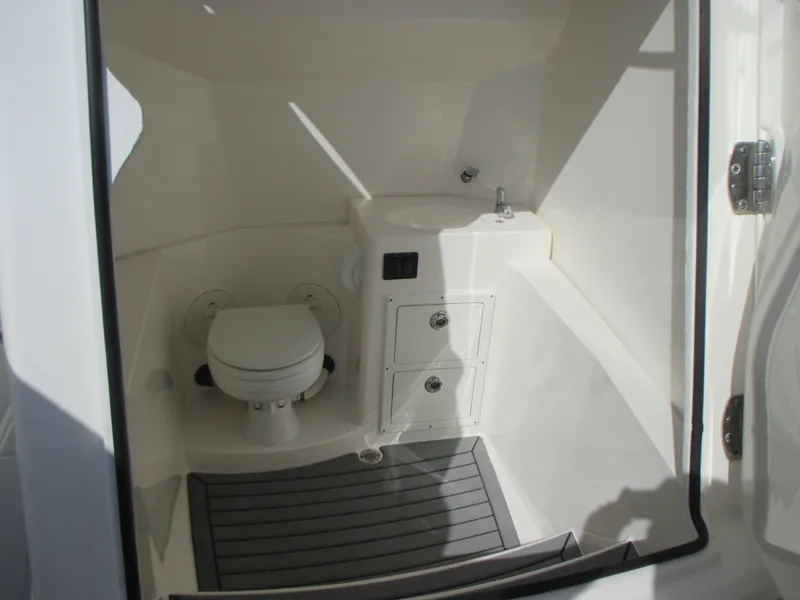 Slide: The Image of 2018 Cobia 301 Center Console boat docked, featuring Garmin radar and spacious seating. - 24