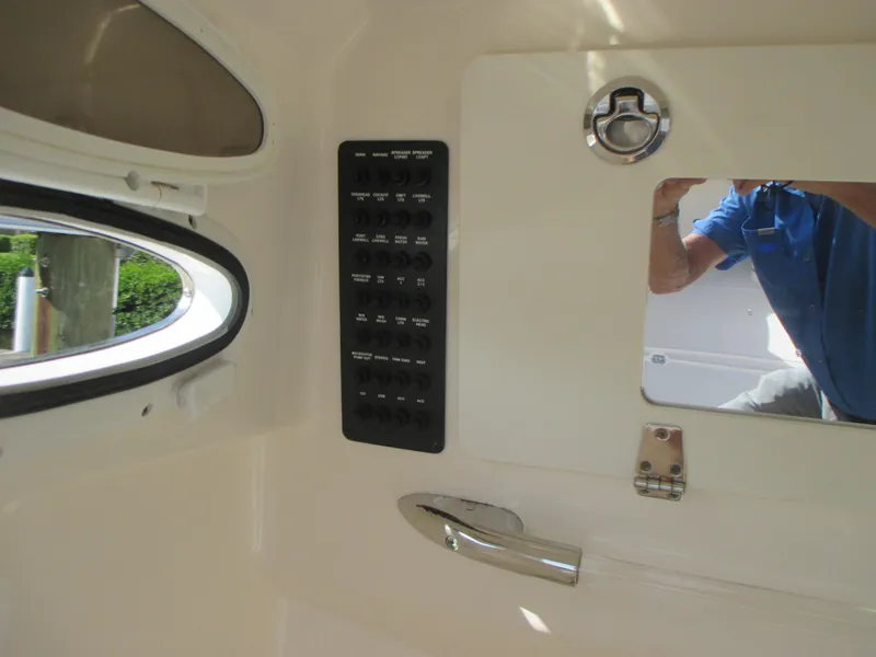 Slide: The Image of 2018 Cobia 301 Center Console boat interior with toilet and sink. - 25