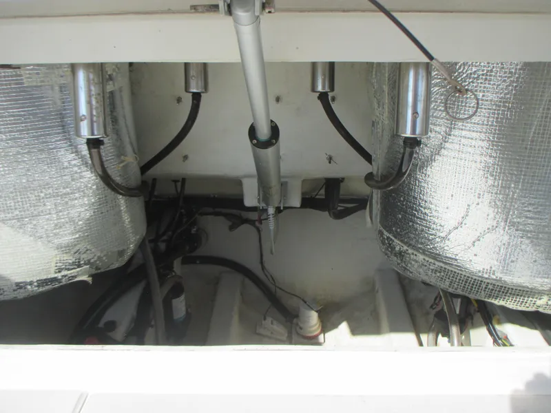 Slide: The Image of 2018 Cobia 301 Center Console engine compartment with hydraulic components and insulation. - 29