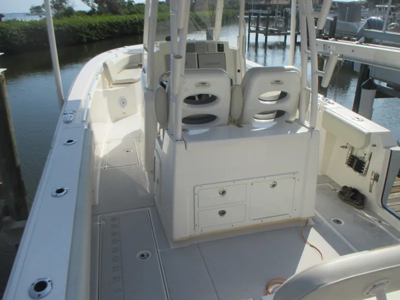Slide: The Image of 2018 Cobia 301 Center Console with dual outboard engines at dock. - 7