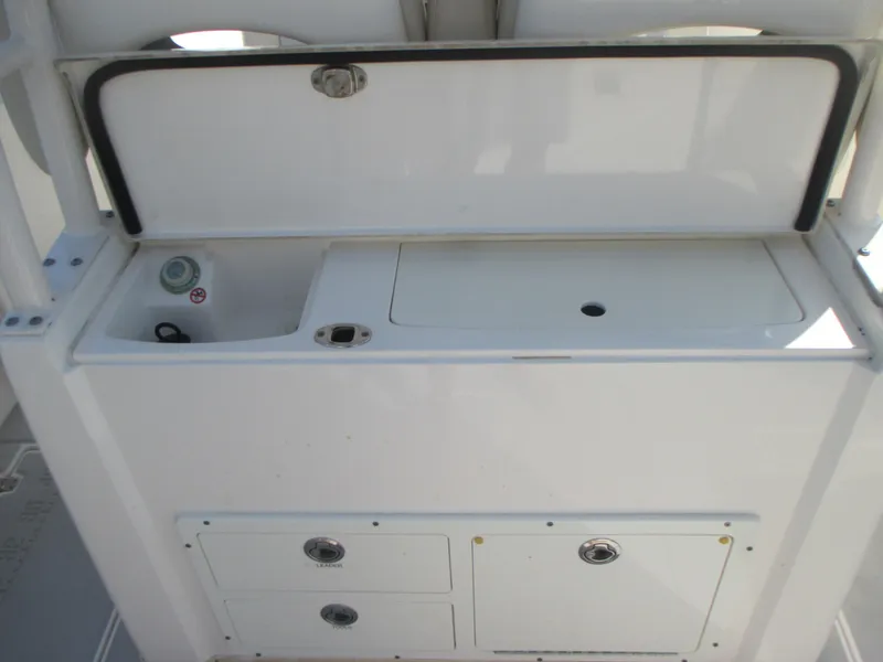 Slide: The Image of 2018 Cobia 301 Center Console boat with dual livewells and rod holders. - 8