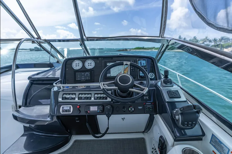 Slide: The Image of 2022 Formula 40 PC yacht cockpit with modern navigation controls and ocean view. - 14
