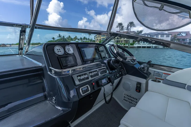 Slide: The Image of Helm of 2022 Formula 40 PC yacht with modern controls and scenic waterfront view. - 16