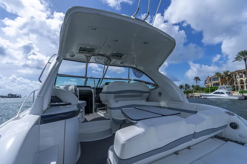 Slide: The Image of 2022 Formula 40 PC yacht interior with seating, under a blue sky and waterfront view. - 21