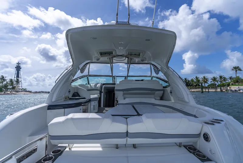 Slide: The Image of 2022 Formula 40 PC yacht interior with seating, ocean view, and lighthouse in the background. - 23