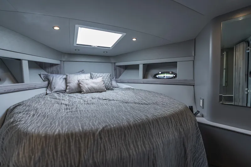Slide: The Image of Luxurious 2022 Formula 40 PC yacht bedroom with skylight and elegant bedding. - 29