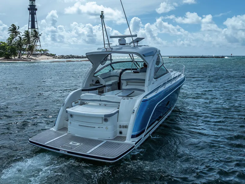 Slide: The Image of 2022 Formula 40 PC yacht cruising near a lighthouse on a sunny day. - 5