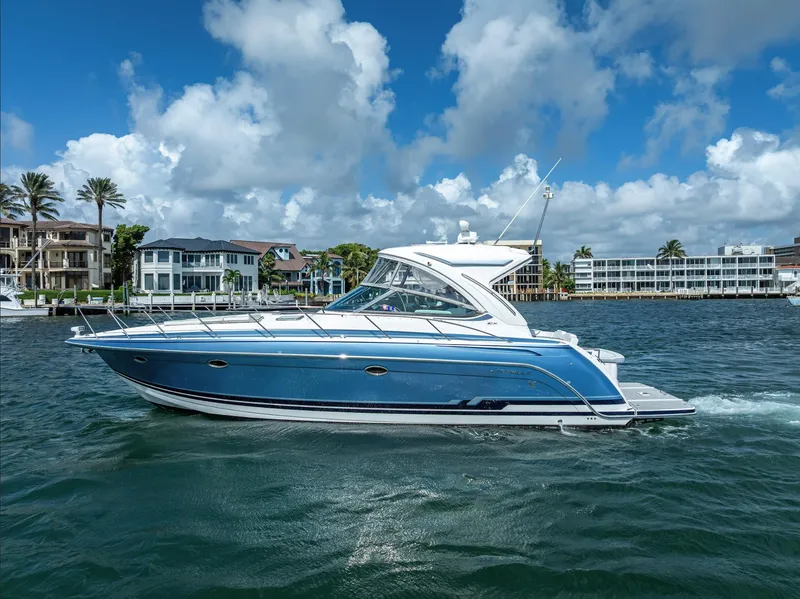 Slide: The Image of 2022 Formula 40 PC yacht cruising on a sunny day with waterfront homes in the background. - 7