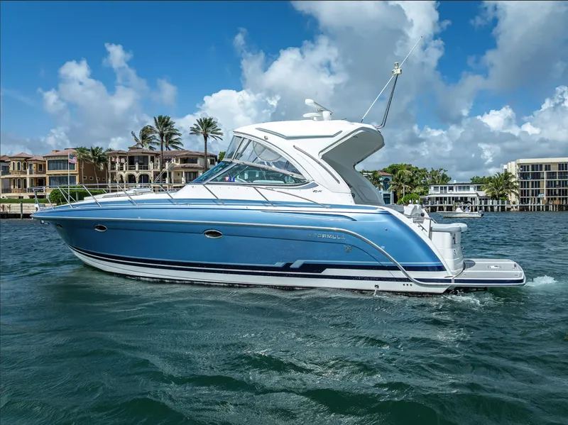 Slide: The Image of 2022 Formula 40 PC yacht cruising on a sunny day, with waterfront homes in the background. - 8