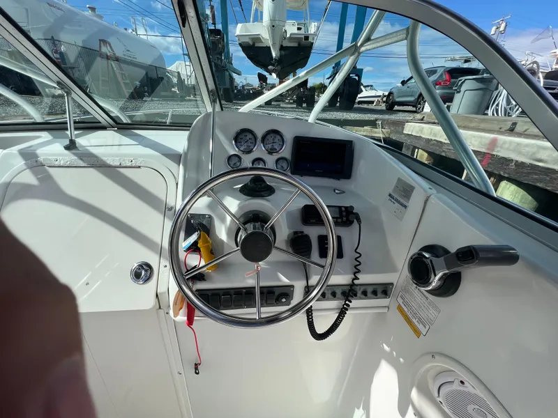 Slide: The Image of 2005 Sailfish 234 WAC boat cockpit with steering wheel and control panel. - 10