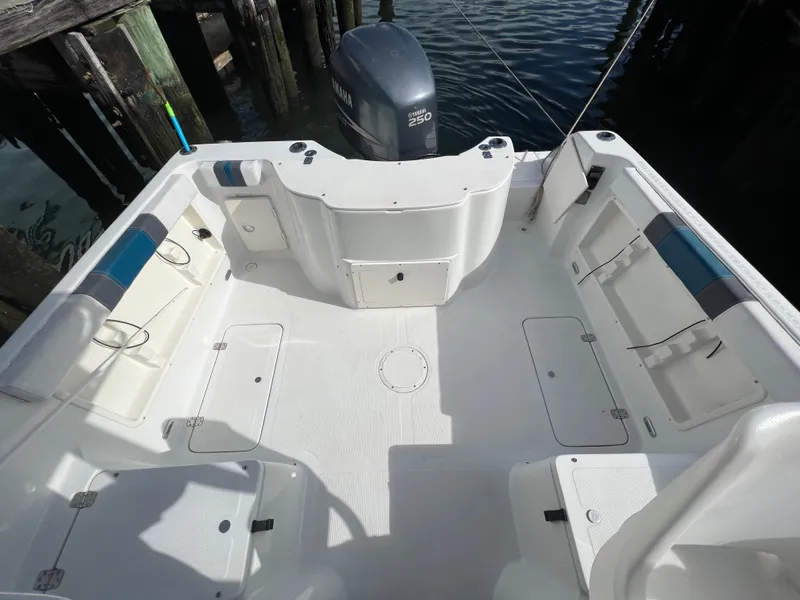 Slide: The Image of 2005 Sailfish 234 WAC boat deck with seating and Yamaha outboard motor. - 14