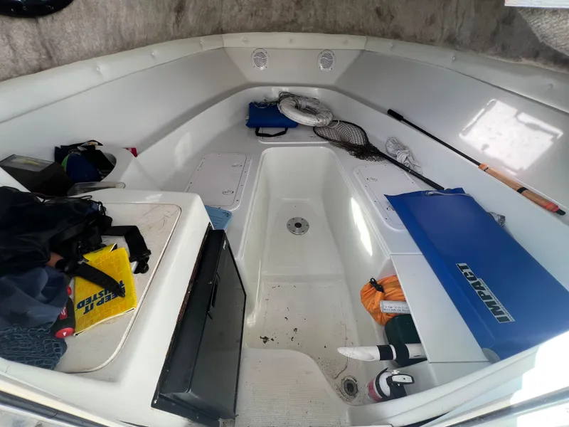 Slide: The Image of 2005 Sailfish 234 WAC boat interior with fishing gear and storage compartments. - 16