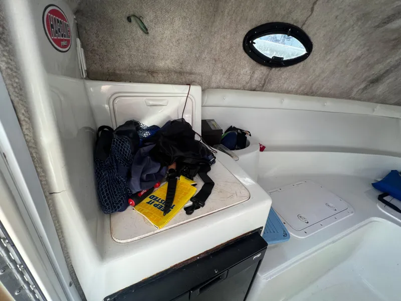 Slide: The Image of 2005 Sailfish 234 WAC cabin interior with storage and gear. - 17
